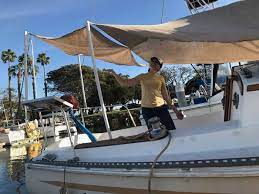 Preparing To Escape To Mexico How To Build A Sun Canopy On A Boat For 120 00 Bimini Dodger Canopy Diy Sailboat Boat Canopy Boat Building Diy Awning