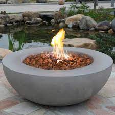Prepare an area for the fire pit, making sure it's a solid, level foundation with base rock or sand. Lunar Concrete Fire Bowl