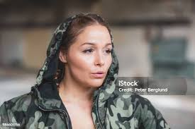 Woman Adjusting Hood On Sports Jacket Stock Photo