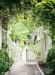 Garden Gate Ideas And Beautiful Gardens To Inspire White Picket Fence Swinging Gates Beneath An Arbor Storybook Gardens Garden Gates And Fencing Garden Gates
