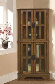 We have tons of dining room corner cabinets so that you can find what you are looking for this season. Coaster Curio Cabinets 4 Shelf Corner Curio Cabinet With Windowpane Style Door Fronts Rife S Home Furniture Curio Cabinets
