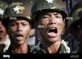 Myanmar soldiers march and sing at the 60th Armed Forces Day ceremonies  Sunday, March 27, 2005, in Yangon. General Than Shwe told assembled  military units and others that Myanmar is moving toward