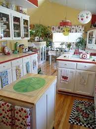 The sunlight and the natural cherry cabinets and floors warm the entire kitchen. A Cute Country Kitchen Retro Kitchen Kitschy Kitchen Vintage Kitchen