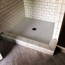 Mix your wood tile pieces with marble tile pieces in matching shades. Wood Tiles On The Floor Subway In The Shower And Penny Rounds On The Shower Floor Of This Pool Bathroom In Harrods Glen Shower Floor Penny Tile Shower Floor Tile Bathroom