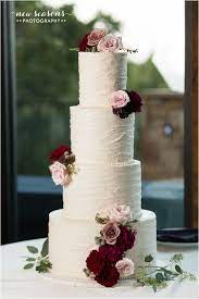 Four Layer White Tall Wedding Cake Tall White Wedding Cake With Flower Embe Wedding Cakes With Flowers Black And White Wedding Cake Bohemian Wedding Cake