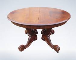 This round dining table features a brown wood finish on the mdf top and solid wood base for a charming farmhouse look. Antique Round Extending Mahogany Dining Table