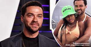 Jesse dresses casually in a white shirt and black gym shorts. Jesse Williams Shares Shirtless Photo With Bikini Clad Girlfriend Taylour Paige