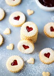 Easy Almond Linzer Cookies Recipe Round Cutout Cookies Sandwiched Together With Strawberry Jam Dusted Linzer Cookies Recipe Jam Cookies Easy Cookie Recipes