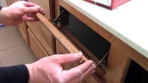 Take a screwdriver and pry the wood facing loose from the plastic wheel. How To Install Kitchen Bathroom Sink Flip Out Drawers Rev A Shelf Youtube