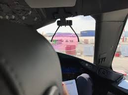 A young boy holding a scottish flag looks out of the window at a boeing 787 dreamliner aeroplane on a runway. My Experience Riding In The Cockpit Of A Boeing 787 Dreamliner During Take Off Pizza In Motion