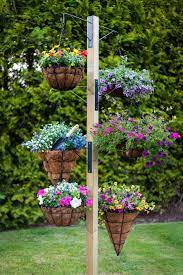 17 Fascinating Examples How To Arrange Hanging Flowers For Your Yard Hanging Basket Garden Colorful Garden Hanging Garden