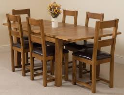 The rectangle dining table features a trestle style base, perfecting the rustic, farmhouse style. Cotswold Extending Rustic Oak Farmhouse Dining Table With 6 Brown Lincoln Dining Chairs