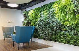 Modern loft interior with furniture lounge chairs, plant, table, architecture concrete cement wall panels. Green Walls Plant Wall Decor Brings Life To Urban Spaces