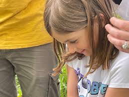 Marston Mills family and Wild Care rescue duckling from drain