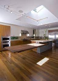 It can be used as the kitchen island is dark while the dining table is ornate with an exclusive silver finish. Cantilevered Tables Floating In Modern Luxury Homes Custom Kitchen Island Kitchen Island Design Kitchen Island Table