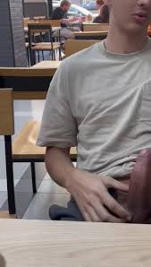 Hung boy showing boner in restaurant - a bold boy reveals his large erection in a unexpected restaurant setting. Provocative male display.