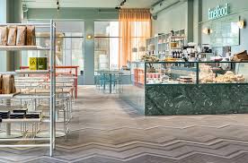 In contrast to the cozy feel of all that is solid, the menu board at the coffee roasting station provides a sleek contrast to the rustic finishes in the. Fine Food Restaurant And Coffee Shop By Note Design Studio Cafe Interiors