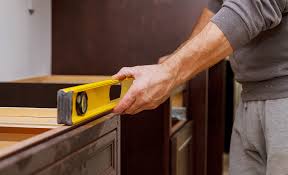 Above the highest spot on the floor. How To Install Base Cabinets The Home Depot