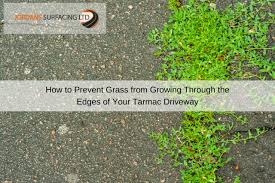 Grass commonly grows in cracked concrete. Preventing Grass Growing Through Tarmac Driveway Jordan S Surfacing