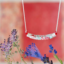 This large sterling silver oval locket features an intricately hand graved floral design with four points on the front and a single chevron on the back. Sterling Silver Necklace With Handmade Red Floral Patterns In Polymer Clay Callistemon