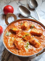 Paneer butter masala in a copper bowl