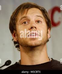 Mac Powell, part of the rock group Third Day, speaks to students and the  media during a news conference announcing a political essay contest