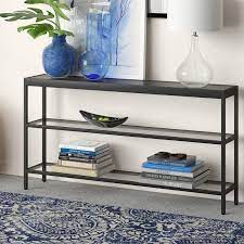 The rae end table is a living room table with high function and a small form that can be a round end table or wood end table. A Steel Framed Console Table With Tempered Glass Shelves So You Can Display Your Finest Knickknackery And Fanciest Books Console Table Living Room Console Black Console Table