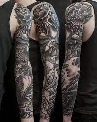 Unterarm band tattoos tattoo unterarm frau oberschenkel tattoos für frauen tattoos frauen arm tattoo frauen tattoo ideen männer weiße wand und eine junge frau mit einer hand mit einem schwarzen tattoo mit kleinen weißen und schwarzen blumen und schwarzen blättern, frauen. Besen Wild At Heart Tattoostudio Munchen