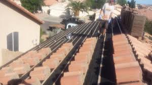 Checking Over A Tile Roof That Has Had The Original Tiles Removed The Underlayment Replaced The Exiting Tiles Are Stacked And Underlayment Roof How To Remove