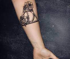 Deathly Hallows Tattoo With Flowers Potterville Harry Potter Luna Lovegood Harry Potter Tattoos Luna Lovegood Tattoo Ideas Tattoos