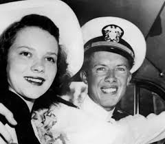 A park ranger rings a farm bell outside of Jimmy Carter's boyhood home 39  times, honoring America's 39th president as his motorcade makes its way to  Atlanta where Carter will lie in