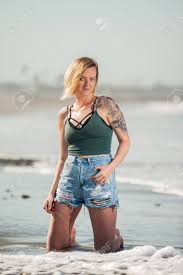 #my upload #gangstajacc #blackwomanmagic #melanin #short hair #blackwomen #haircut #waves #pixie. Short Hair Girl Kneeling In The Beach Surf As Waves Lap Behind Stock Photo Picture And Royalty Free Image Image 82224786