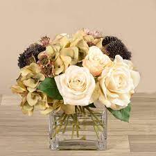It comes with a stylish vase with a square base for stability. Mixed Flower Arrangement In Square Glass Vase
