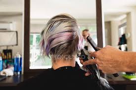 But what about straight hair? Rear View Close Up Of A Middle Aged Caucasian Male Hairdresser And A Young Caucasian Woman Having Her Hair Trimmed In A Hair Salon Reflected In A Mirror Fashion Individuality