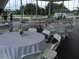 White Hercules Chairs And 60 Round Tables At The Jim Ellis Audi Atlanta Showroom Par Round Table And Chairs Shabby Chic Table And Chairs Table Linen Rentals