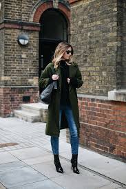 Black Ankle Boots With Skinny Jeans Emma Hill Wears Khaki Coat Black Sweater Ripped Skinny Jeans Black Vinyl Patent Heeled Ankle Boots Large Bla Chic Winter Outfits Boating Outfit Khaki Coat