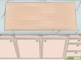 So all you need to do is to remove the screws that are holding the cabinet to the counter top, the other cabinet (s), and the wall, and then you should be able to remove the cabinet. 3 Ways To Remove Kitchen Cabinets Wikihow
