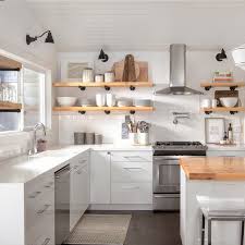 Check spelling or type a new query. A Clean White Minimalist Kitchen With Light Wood Floating Shelves And Matte Black Lighting Fixtures Kitchen Design Small Kitchen Cabinet Trends Kitchen Remodel