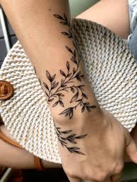 A tattoo that runs from the wrist down the fingers to the middle knuckle. Wraparound Vines Wrap Around Wrist Tattoos Wrap Around Tattoo Wrist Tattoos For Women