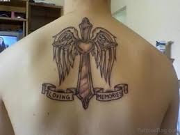 The cross has pointed edges and a seemingly embossed body, with a ribbon featuring a message looped gracefully around it. 80 Stylish Cross Tattoos On Back