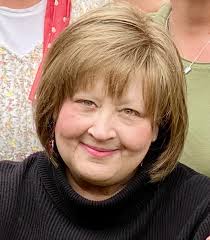 This is my sister in law who passed away last week. i am hoping one of you  magicians can sharpen and possibly change the background to something  prettier. it would be so