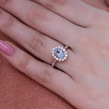 For instance, a ring might have an aquamarine gemstone surrounded in black or white diamonds. Luna Halo Oval Engagement Ring W Aquamarine And Diamond In Scalloped Band La More Design