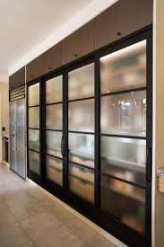 Black Framed Sliding Frosted Glass Doors Conceal Shelving And Pantry Storage Kitchencabinetswhite Pantry Design Glass Kitchen Cabinets Kitchen Room