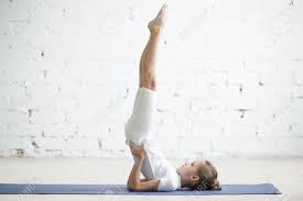 A common error is to stop pushing as the shoulders pass the rings. Girl Child Practicing Yoga Standing In Salamba Sarvangasana Exercise Supported Shoulder Stand Pose Working Out Wearing Sportswear T Shirt Pants Indoor Full Length White Loft Studio Background Stock Photo Picture And Royalty Free
