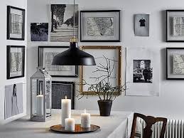 A Wall Filled With Picture Frames In Black And Gold Color With Black White Pictures A Beige Tablec Ikea Pendant Light Ikea Inspiration Interior Design Gallery