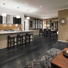 Wonderful Kitchen And Dining Room With Long Island And Dark Dining Table On Grey Hardwood Floors Grey Flooring Grey Hardwood Floors Grey Kitchen Colors