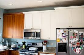 The doors were made at a different shop and mom's glass front cabinets are filled with things that have meaning. Diy Painting Our Kitchen Cabinets With White Milk Paint Catz In The Kitchen