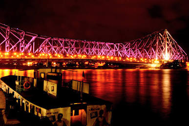 Howrah Bridge illuminated over the Hooghly, AI generated