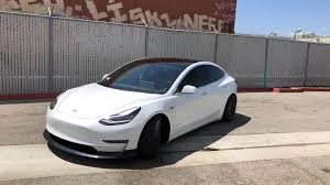 first look at the up durable urethane front lip spoiler installed unpainted on this slammed dual motor performance model 3 first fro tesla model model tesla