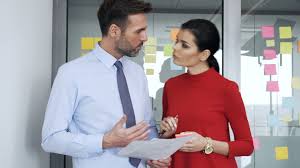 Businessman And Business Woman Discuss Some Papers At Corporate Office Stock Footage Woman Discuss Businessman Business Business Women Business Man Women